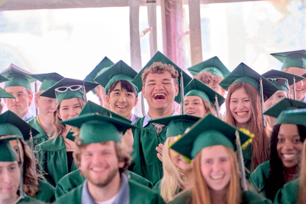Smiling students in their cap and gowns for graduation